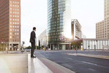 Germany, Berlin, Businessman standing on balustrade - FKF000609