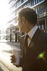 Germany, Berlin, Businessman holding coffee cup - FKF000619