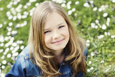 Portrait of smiling girl on flower meadow - GDF000413