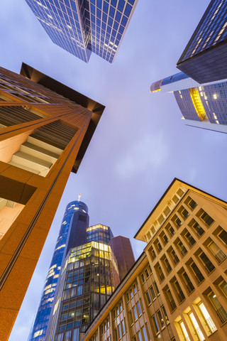 Deutschland, Hessen, Frankfurt, Blick auf Fassaden moderner Bürogebäude von unten in der Dämmerung, lizenzfreies Stockfoto