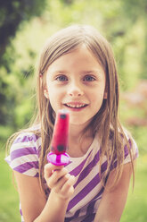 Portrait of little girl with popsicle in the garden - SARF000786