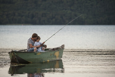 Germany, Rhineland-Palatinate, Laacher See, father and son fishing from boat - PAF000916