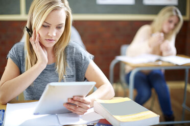 Female student in classroom using digital tablet - ZEF000752