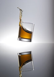 Whiskey splashing in glass - KSWF001326