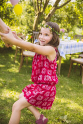 Girl pulling adult's arm in garden - MFF001270