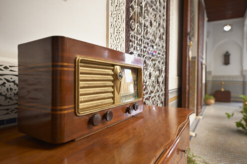 Morocco, Fes, old radio on a chest of drawers at Hotel Riad Fes - KMF001482