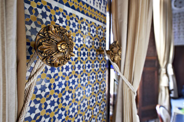 Morocco, Fes, Hotel Riad Fes, tied curtain and wall mosaic - KMF001487