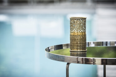 Morocco, Fes, Hotel Riad Fes, tea light holder on side table near the pool - KMF001473