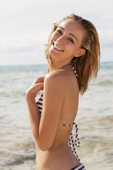 Spain, Mallorca, portrait of smiling young woman on the beach - JUNF000027