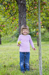 Porträt eines kleinen Mädchens, das sich an einen Apfelbaum lehnt - LVF001798