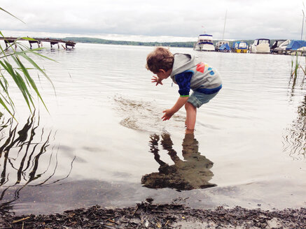 Boy wading in water - AFF000115