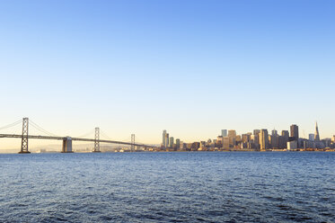 USA, California, San Francisco, Oakland Bay Bridge and skyline of Financial District in morning light - BRF000681