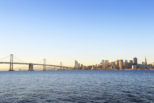 USA, California, San Francisco, Oakland Bay Bridge and skyline of Financial District in morning light - BRF000681