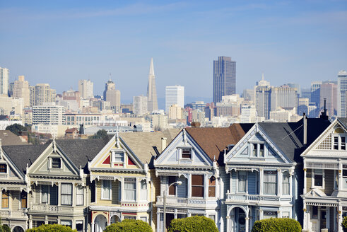 USA, California, San Francisco, Victorian houses at Alamo Square in front of the skyline - BRF000691