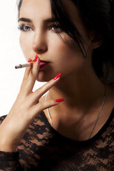 Portrait of smoking young woman with red nail polish - JUNF000032