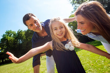 Little girl playing in the park with her parents - CHAF000143