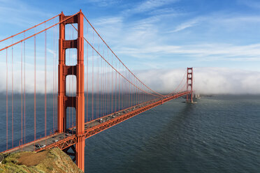 USA, California, San Francisco, Golden Gate Bridge seen from Hawk Hill with fog hiding city - FOF007027