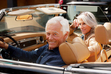 Portrait of a smiling senior couple sitting in a convertible car - CHAF000170