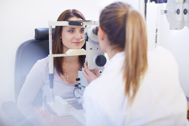 Eye doctor examining woman's vision - ZEF000612