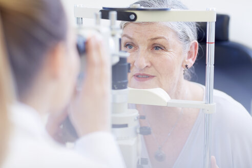 Eye doctor examining senior woman's vision - ZEF000651