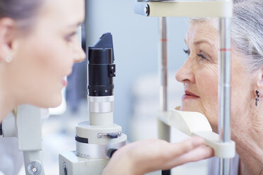 Eye doctor examining senior woman's vision - ZEF000652