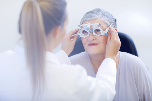 Eye doctor examining senior woman's vision - ZEF000654