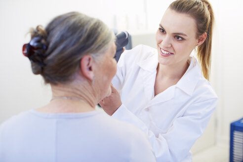 Eye doctor examining senior woman's vision - ZEF000664