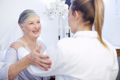 Smiling senior woman at the eye doctor stock photo