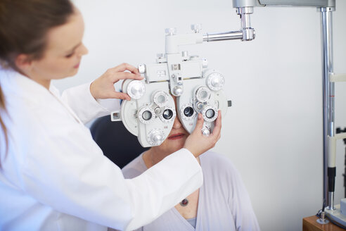 Eye doctor examining senior woman's vision - ZEF000701