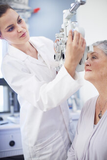 Eye doctor examining senior woman's vision - ZEF000703