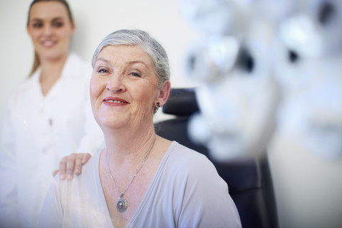 Portrait of smiling senior woman at the eye doctor stock photo