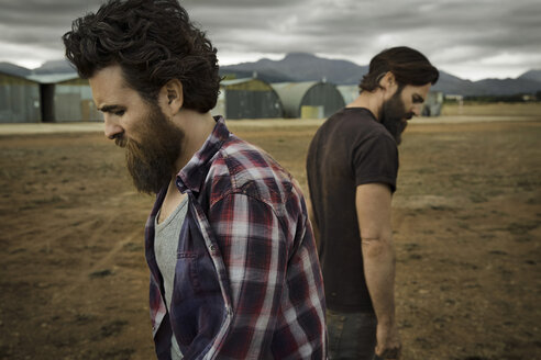 Two men with full beards in abandoned landscape - KOF000020