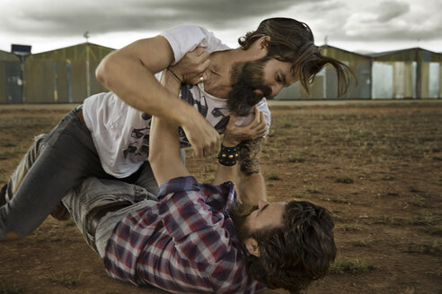 wo men with full beards fighting in abandoned landscape - KOF000027