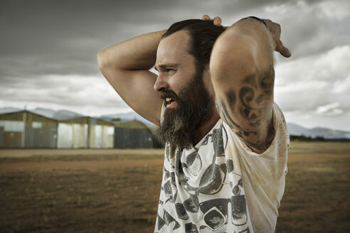 Man with full beard in abandoned landscape - KOF000033
