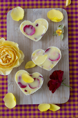 Rose butter and rose petals on chopping board stock photo