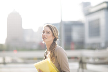 Portrait of businesswoman with file - ZEF000217