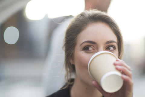 Portrait of businesswoman drinking coffee to go stock photo