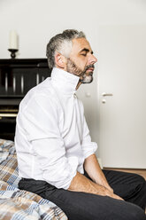 Businessman relaxing in his bedroom - MBEF001167