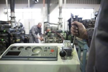 Worker at machine in factory - ZEF000626