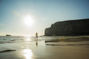 France, Brittany, Camaret-sur-Mer, teenage girl running in the ocean - UUF001788