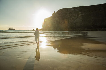 Frankreich, Bretagne, Camaret-sur-Mer, ältere Frau am Strand stehend - UUF001789