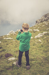Italy, Lake Garda, Malcesine, Monte Baldo, boy taking a photo - SARF000819