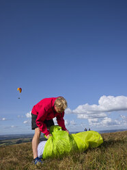 Man packing his paraglider - LAF001041