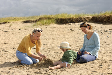 Frankreich, Bretagne, Sainte-Anne-la-Palud, Mutter und ihre beiden Töchter sitzen auf einer Stranddüne - LAF001140