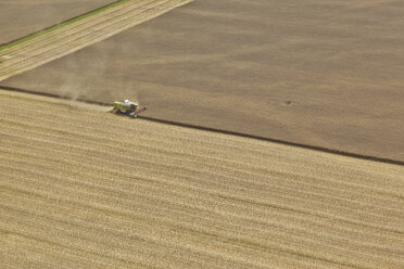 Germany, Bavaria, aerial view of combine harvester on cornfield - KDF000033