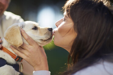 Woman kissing dog puppy - ZEF000400