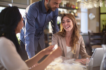 Business meeting of three people in a restaurant - ZEF000896