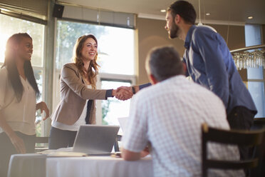 Two people greeting each other at a business meeting in a restaurant - ZEF000903