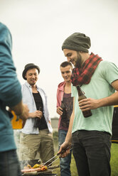 Group of friends drinking beer and having a barbecue - UUF001856