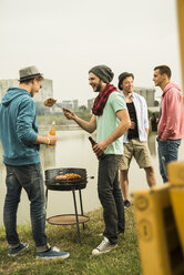 Group of friends drinking beer and having a barbecue - UUF001858